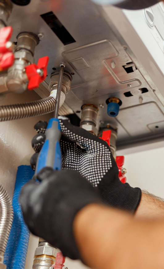 closeup of plumber using screwdriver while install new kensington pa